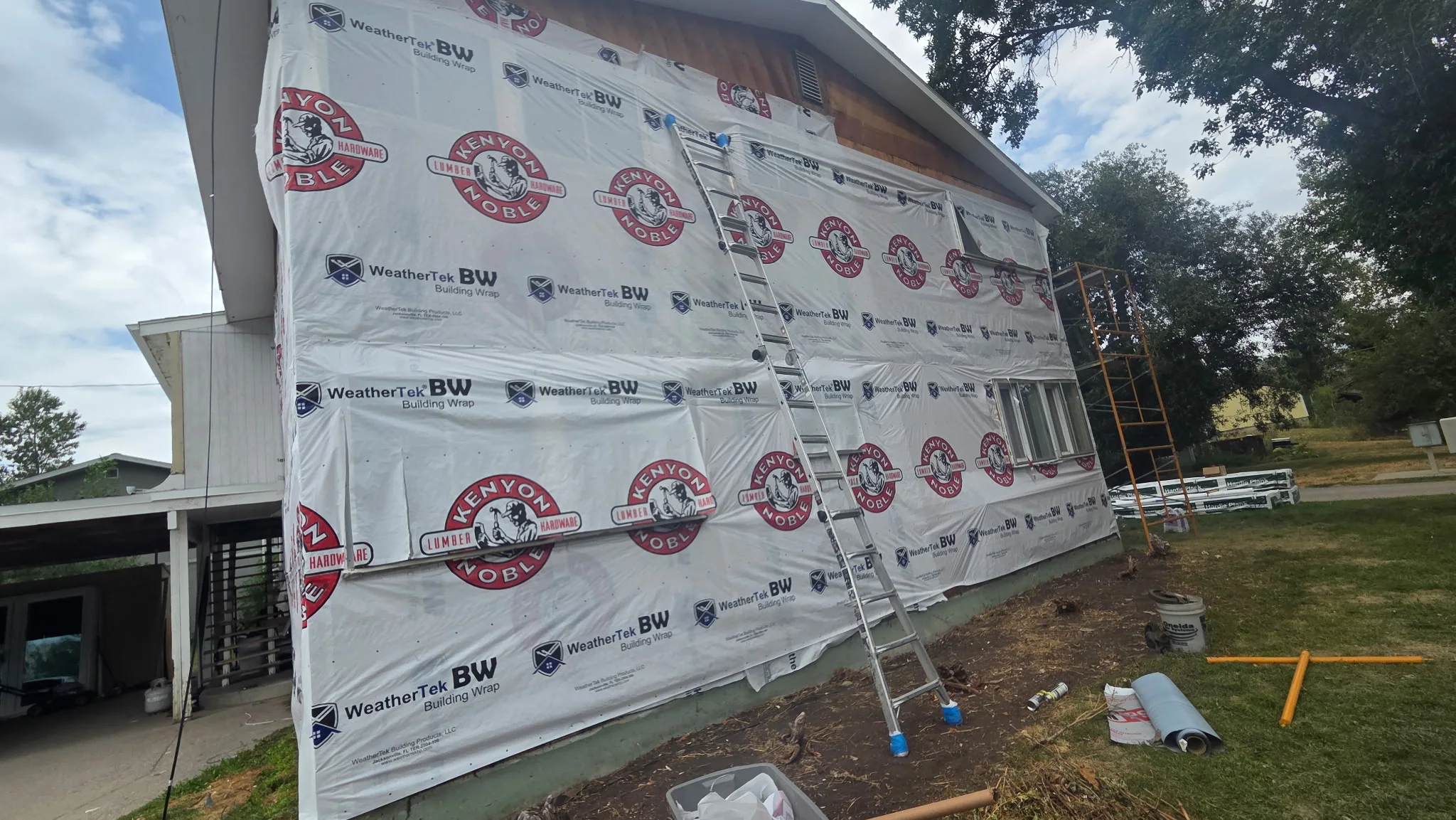 House wrap fully exposed after siding removal on Bozeman home