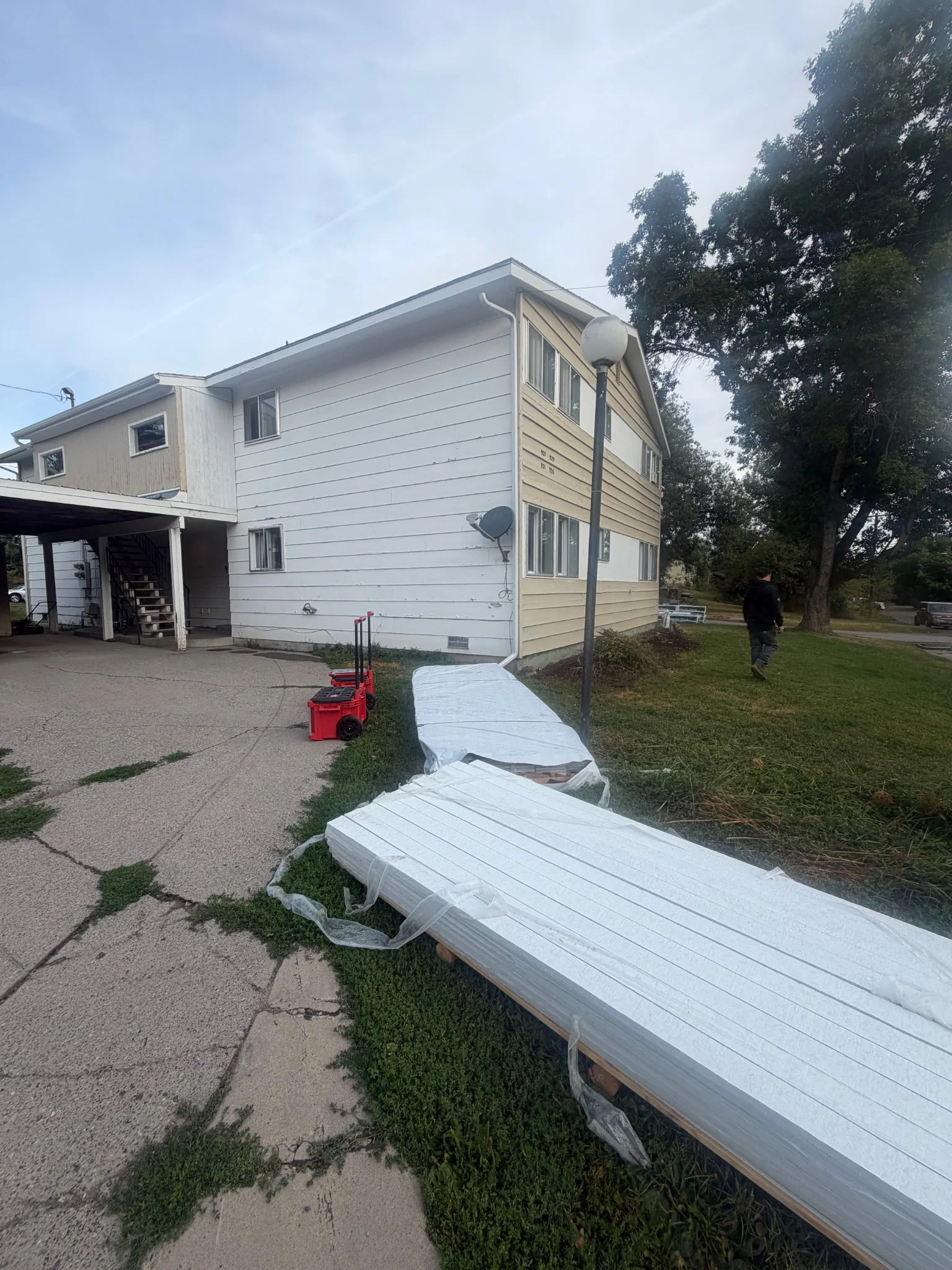 Progress photo showing siding removal mid-job