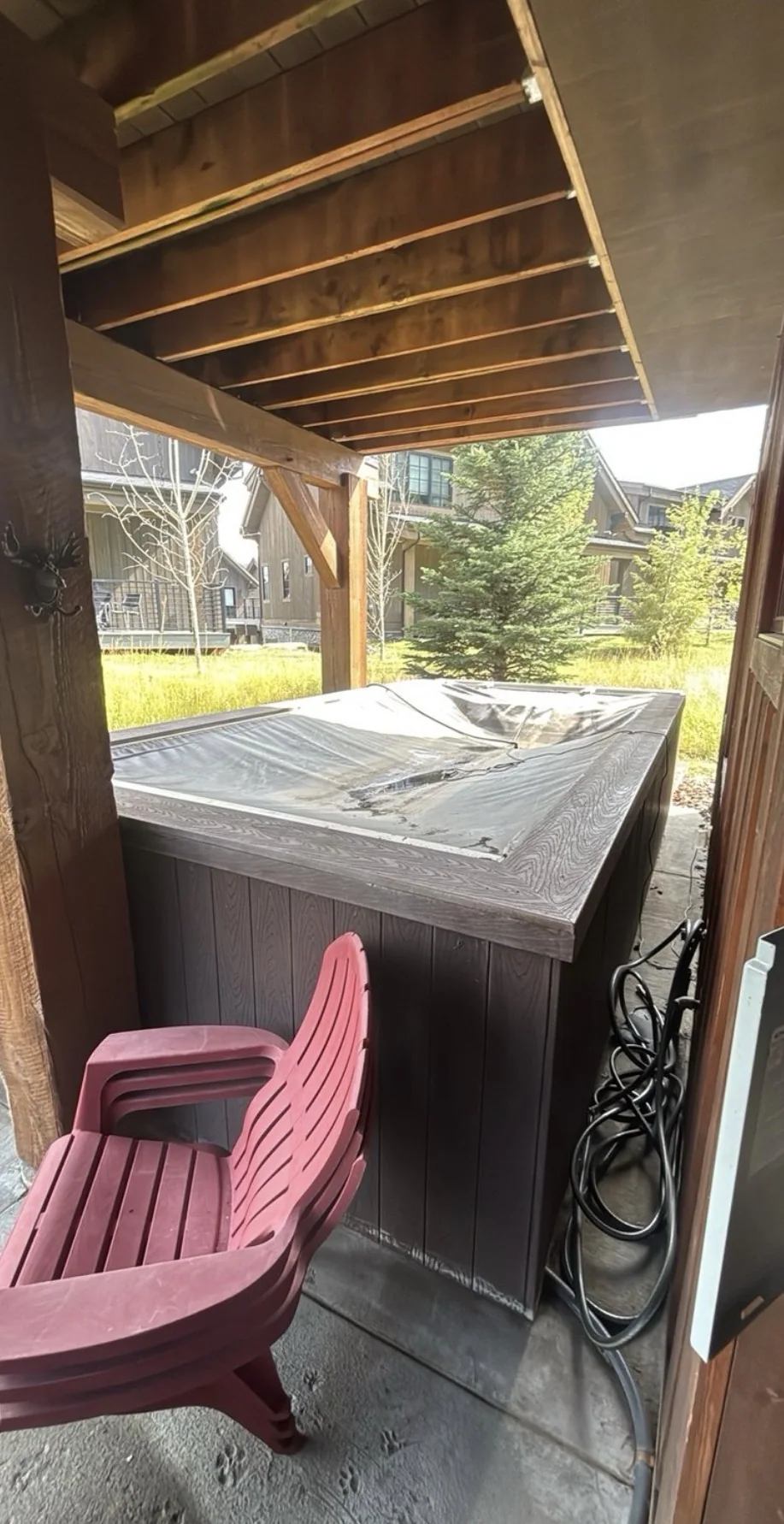 Second before photo showing full covered patio hot tub setup